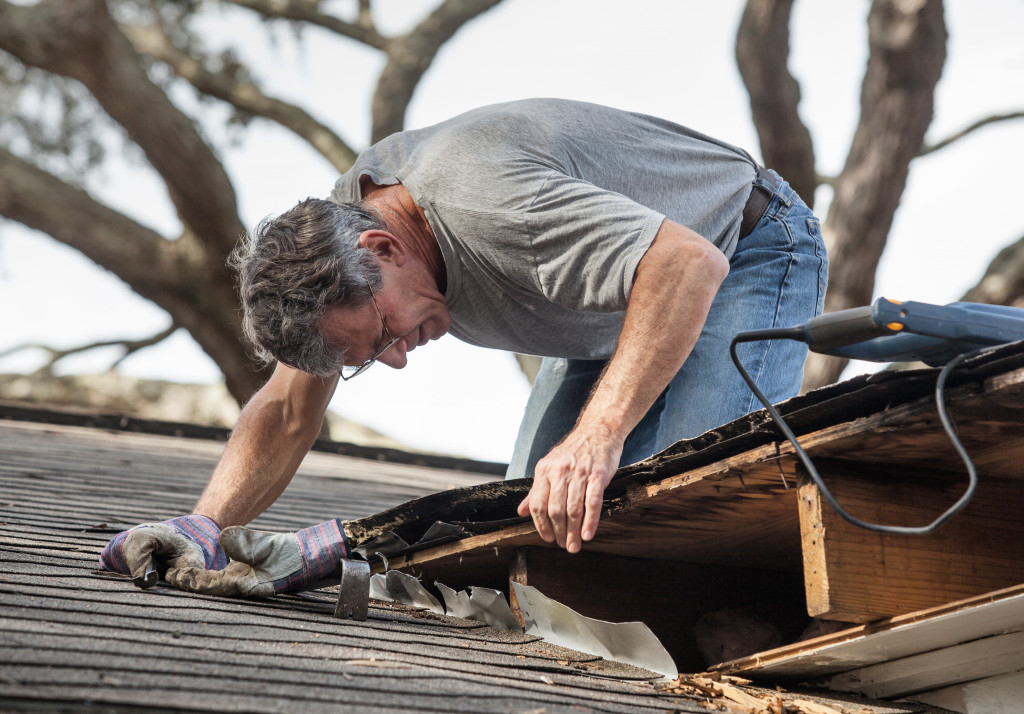 man checking roof